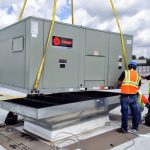Thumbnail of http://Workers%20installing%20a%20large%20rooftop%20HVAC%20unit.