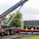 Thumbnail of http://Workers%20operate%20a%20crane%20truck%20on%20a%20construction%20site%20under%20cloudy%20skies.