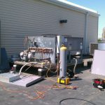 Thumbnail of http://Industrial%20equipment%20setup%20outside%20a%20building%20with%20gas%20cylinders%20and%20machinery.