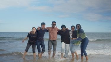 A group of students having fun on the beach