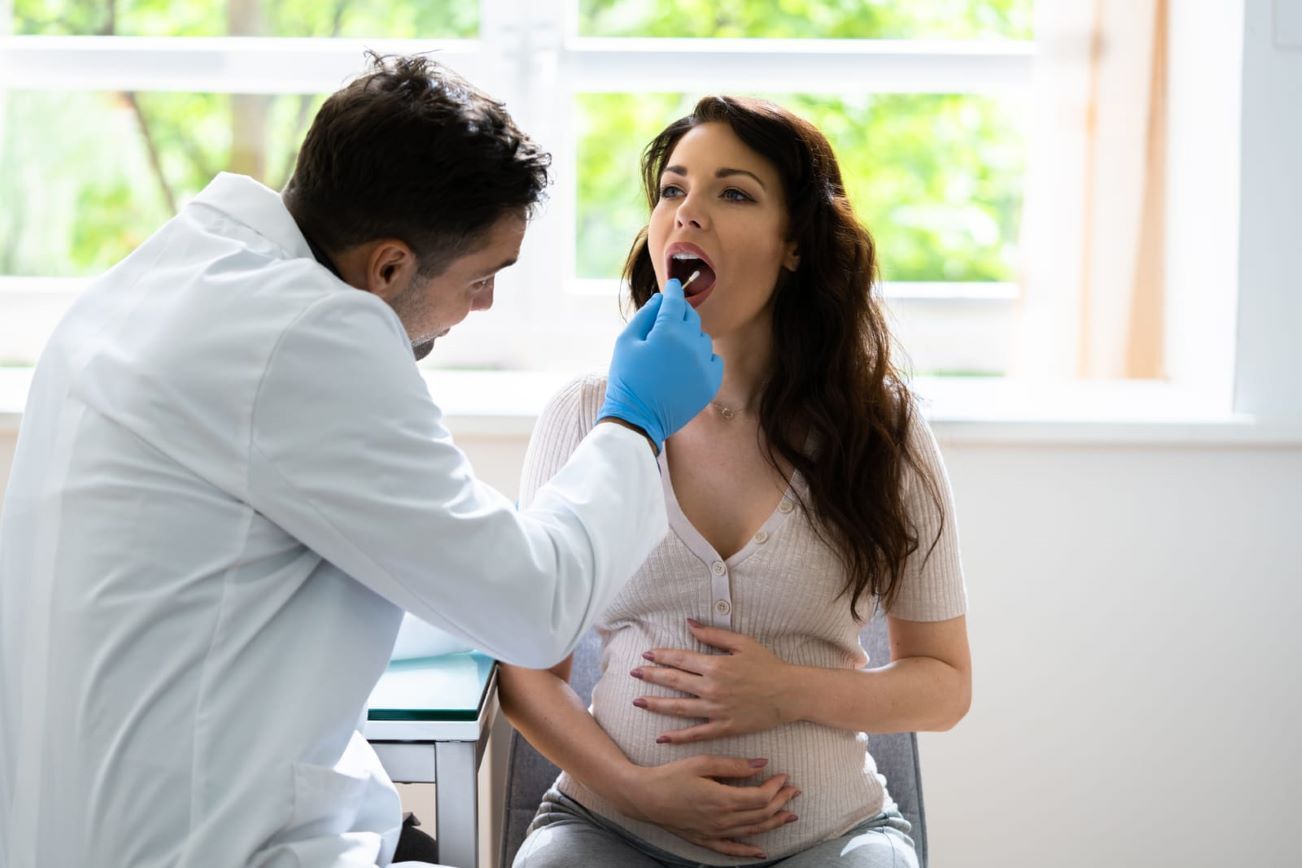 Close-up of a woman undergoing DNA testing with a mouth swab