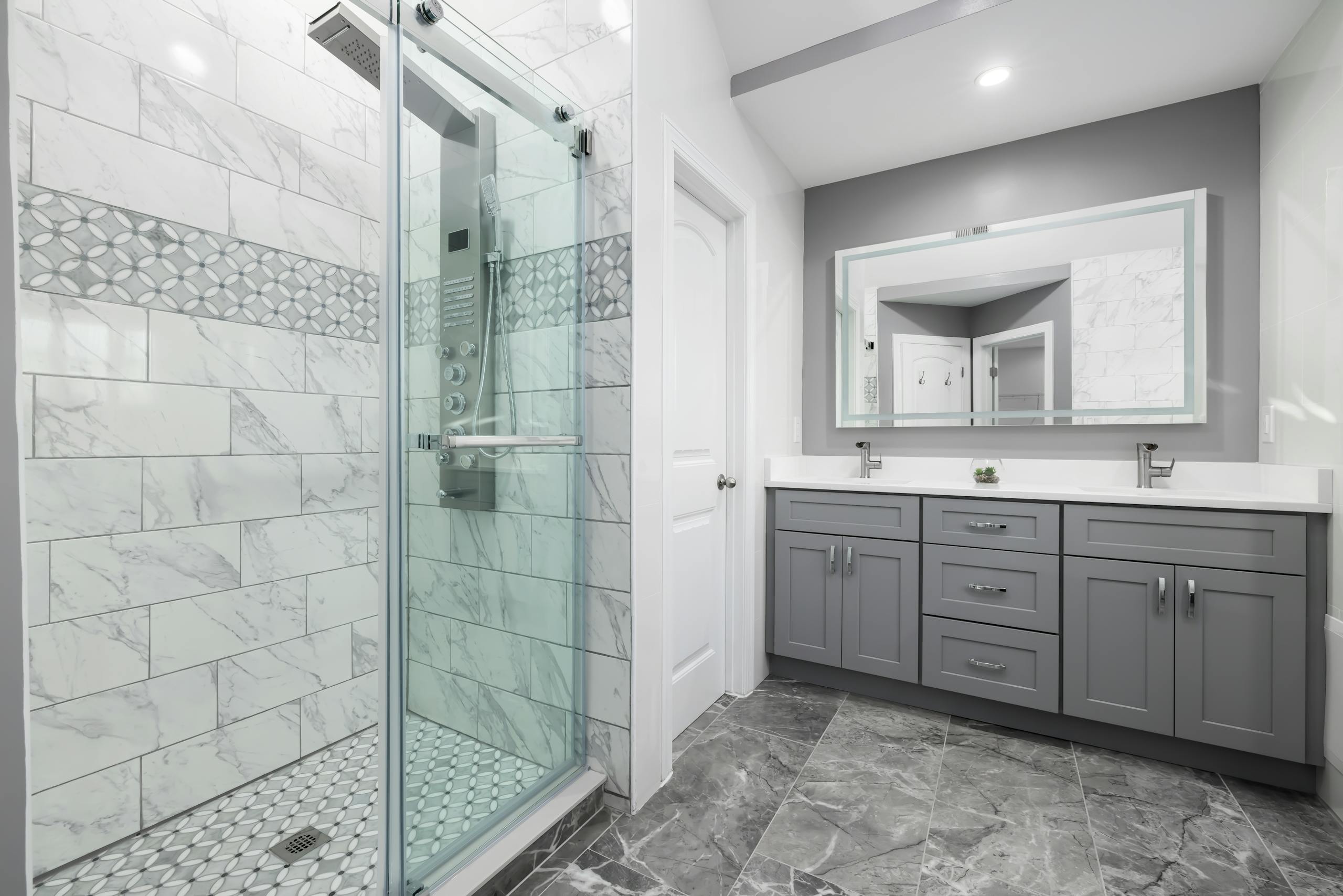 Bathroom renovation inspiration with a tiled shower and grey vanity