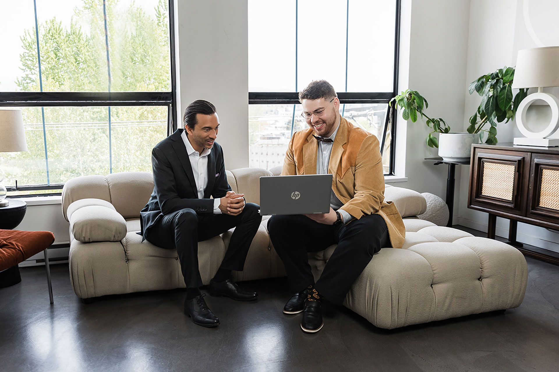 safe pacific advisors looking at a laptop sitting on a couch