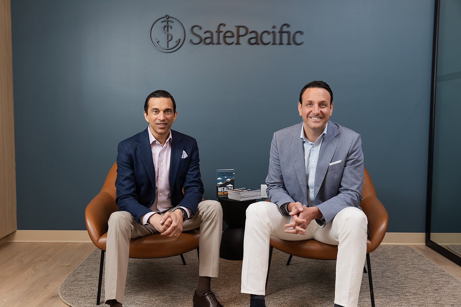 Two advisors in business attire at SafePacific discuss infinite banking, bespoke wealth management, and Canadian life insurance.
