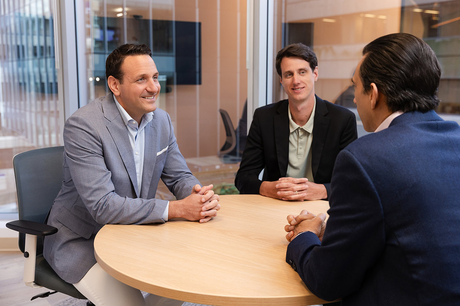 Three advisors discuss wealth management, infinite banking, and bespoke Canadian life insurance at Safe Pacific Financial’s office.