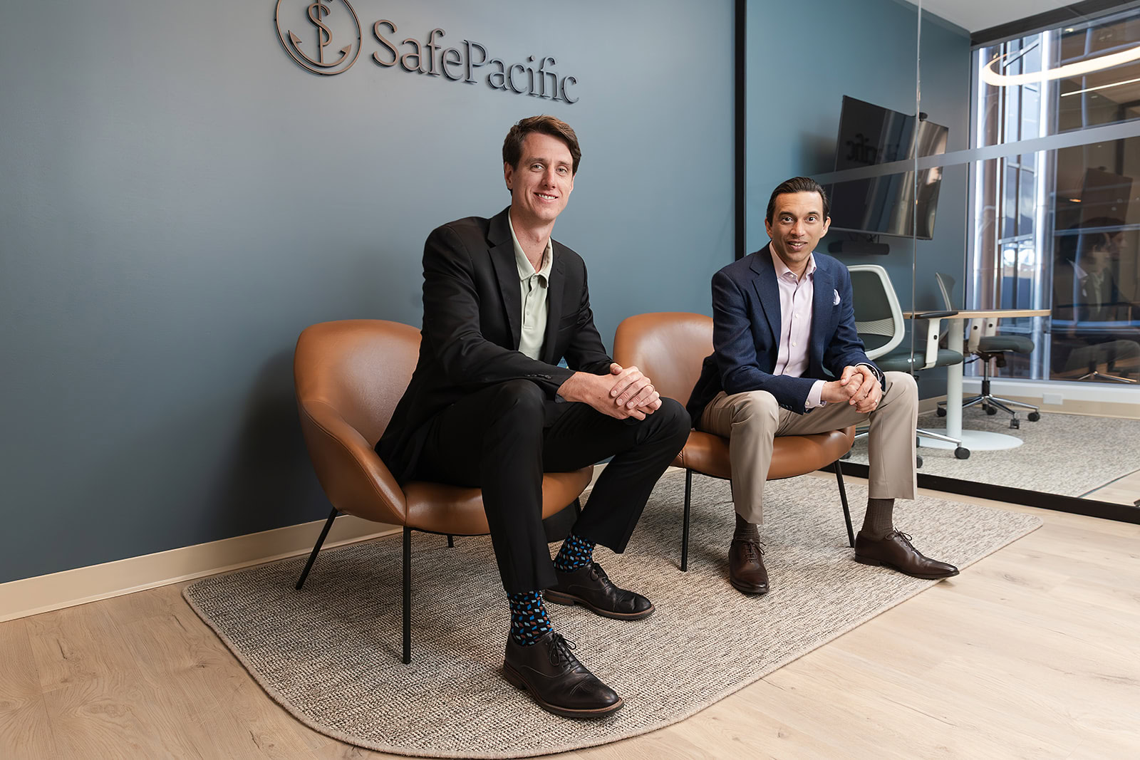 Two advisors discuss wealth management, infinite banking, and bespoke Canadian life insurance at Safe Pacific Financial’s modern office.