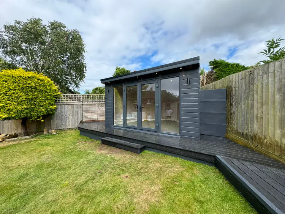 conservatory with large doors in front of a lawn