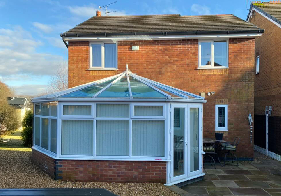 conservatory with white framed doors and windows