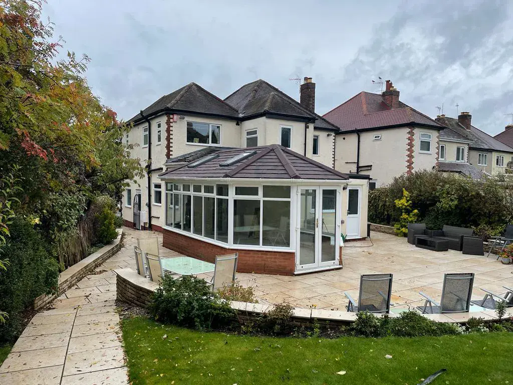 white framed glass panel in cream coloured conservatory