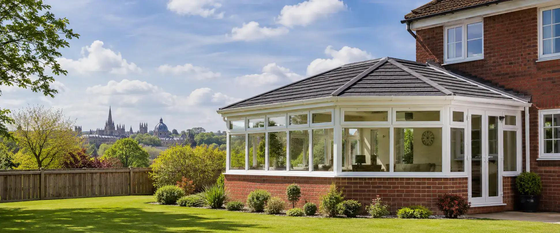 Conservatory roof replacement in Oxford featuring a modern solid tiled conservatory roof on a detached home with landscaped garden and improved energy efficiency.