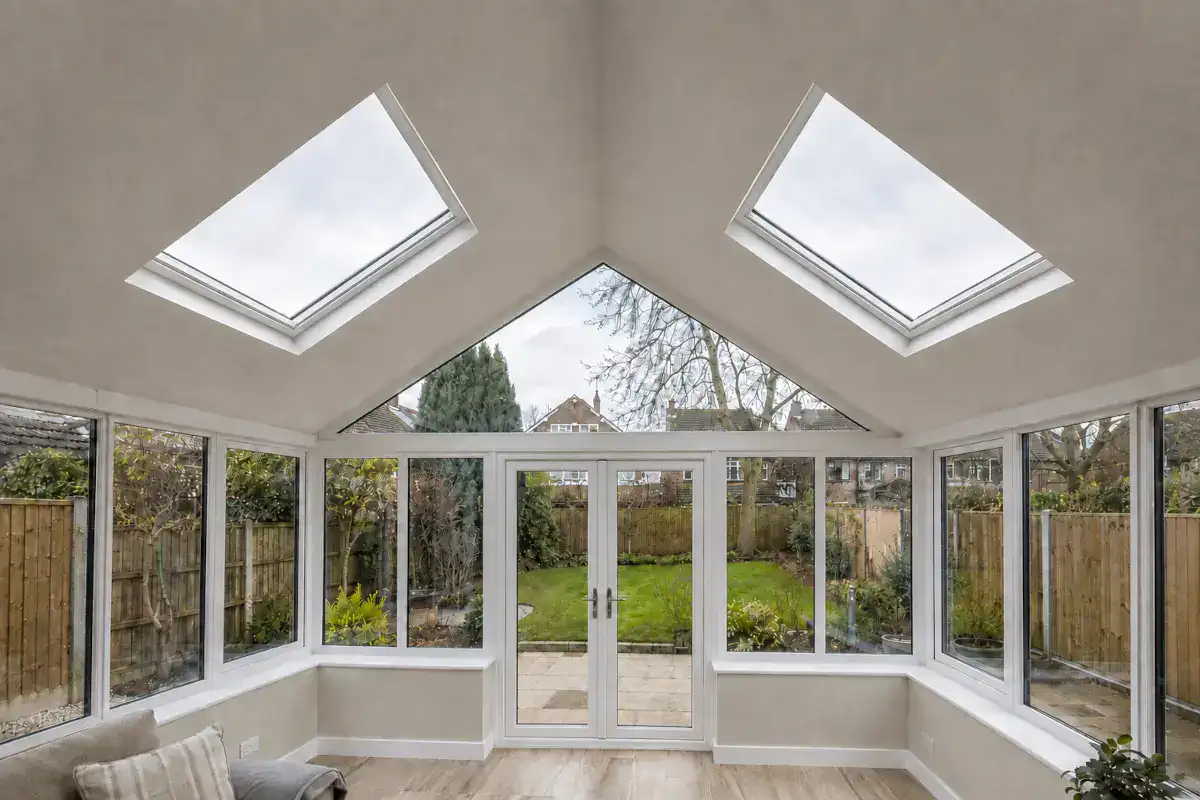 Conservatory roof replacement interior with insulated warm roof, plastered vaulted ceiling and two roof windows