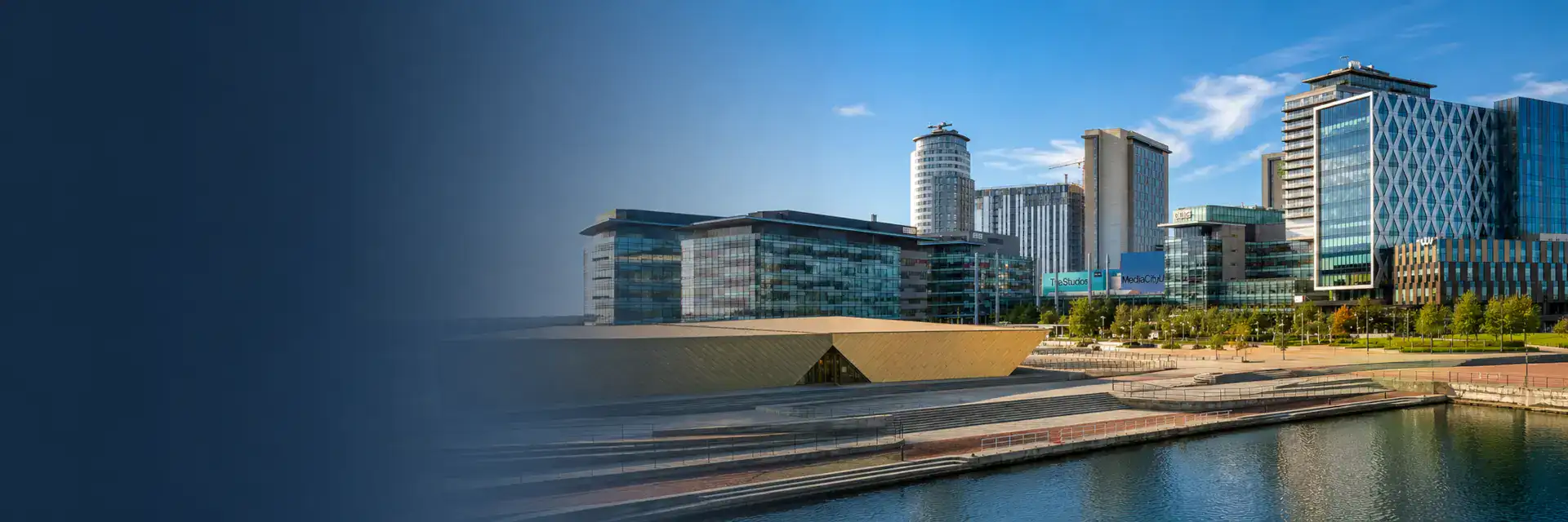 Home Improvements in Salford banner showing the MediaCity waterfront skyline, modern buildings and canal on a bright summer day.