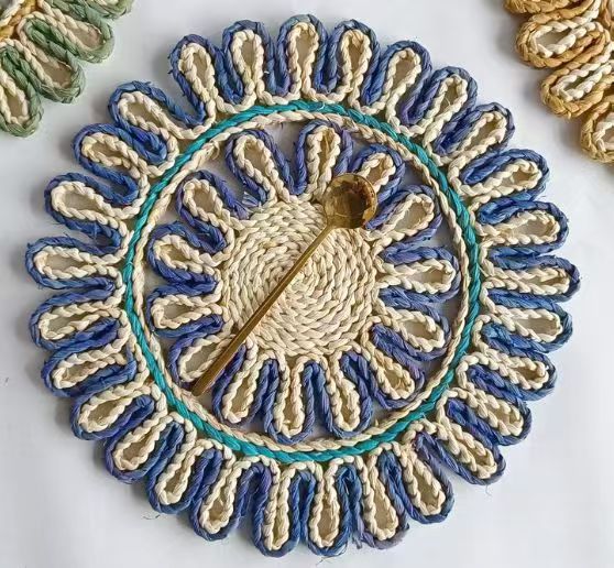 Hand-braided scalloped placemat on a wooden table