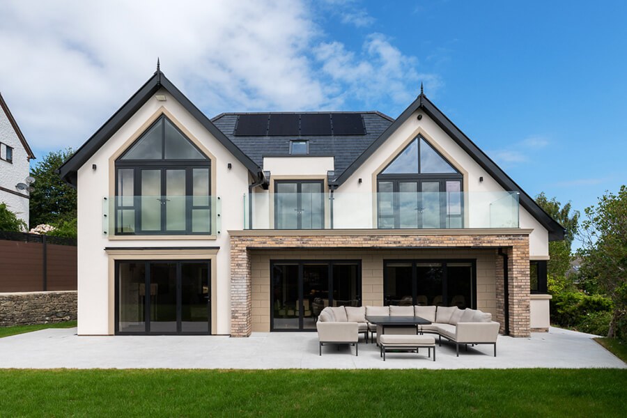 Grey aluminium windows and bifold doors on modern house backgarden view