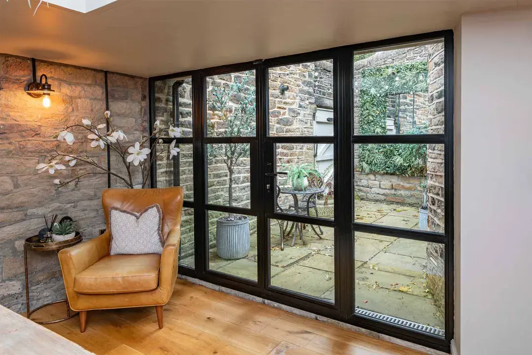 Decorio black aluminium glazed door opening from living room to patio
