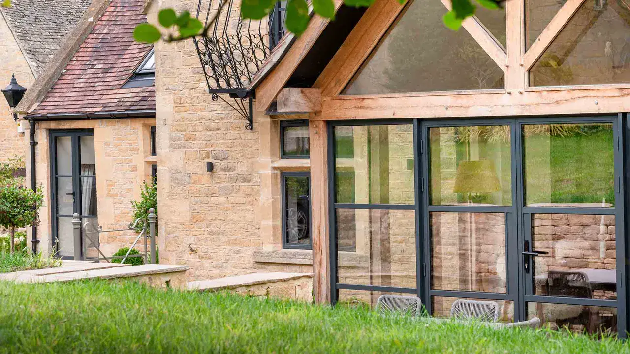 Decorio heritage aluminium door with steel-look glazing on stone house extension