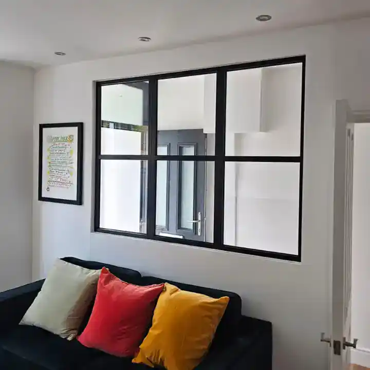 Decorio internal aluminium screen with black grid frame dividing living room space