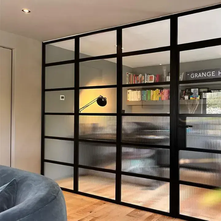 Decorio aluminium screen with black grid frame and glazed panels dividing interior space