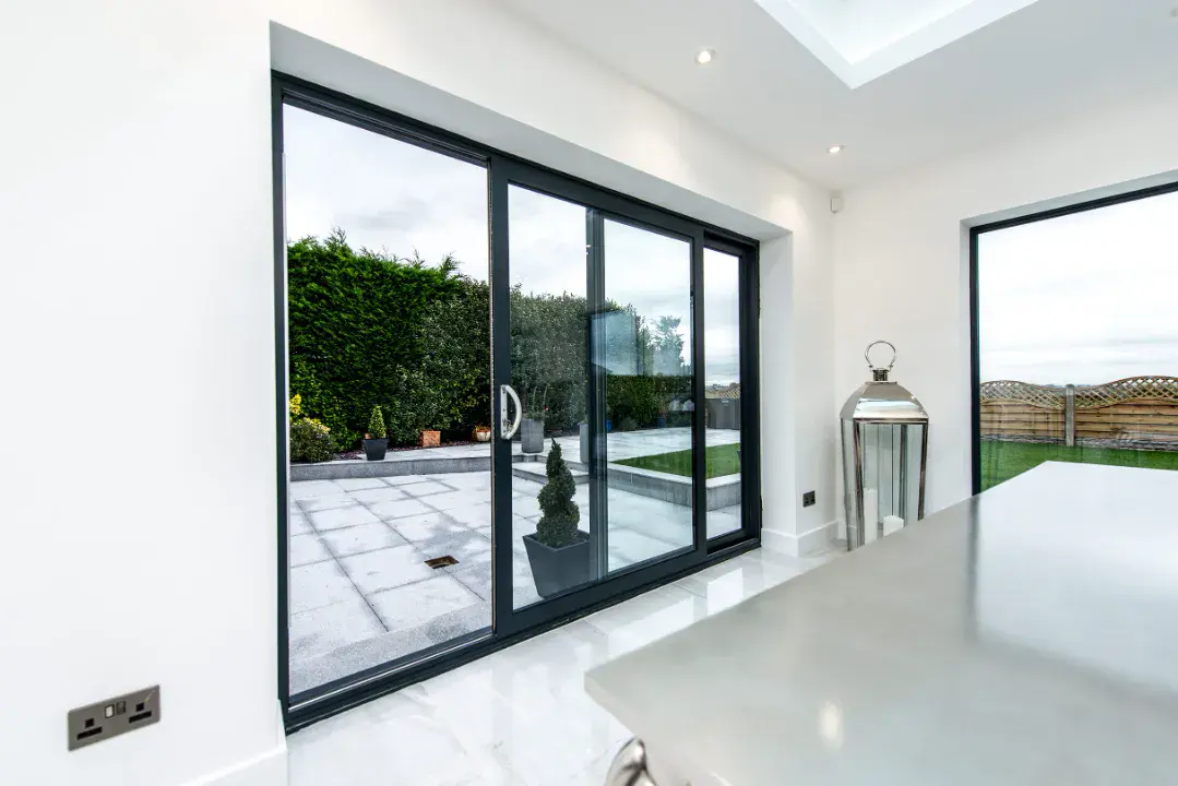 Midland aluminium sliding door in modern kitchen opening to paved patio garden