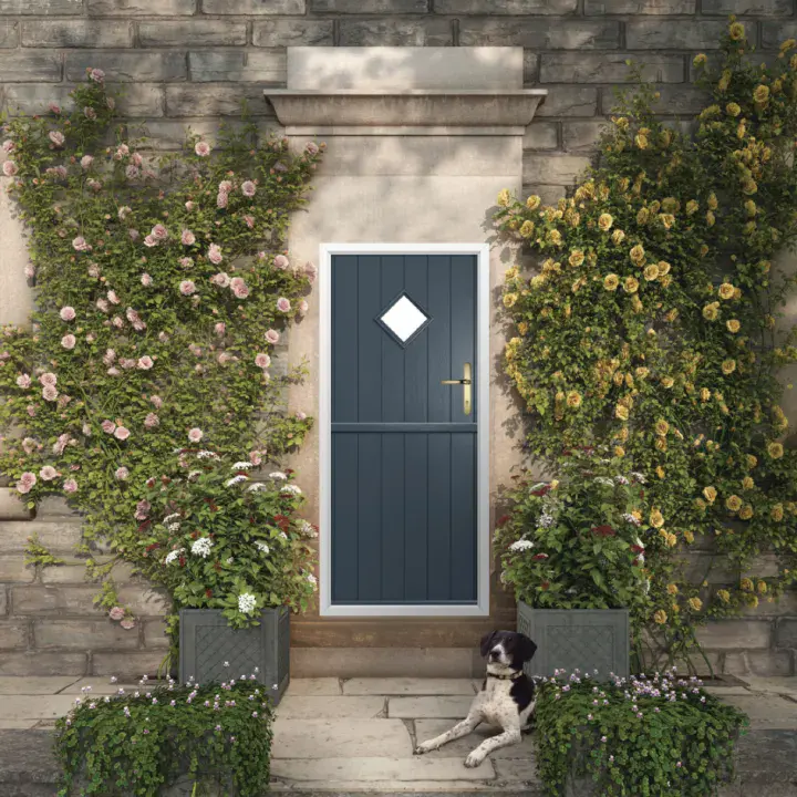 Solidor grey stable composite door with diamond glazed panel in stone cottage garden entrance