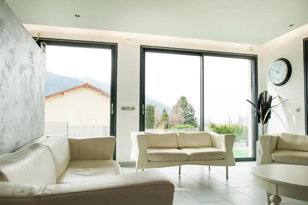 Black aluminium sliding patio doors fitted to a bright modern living room