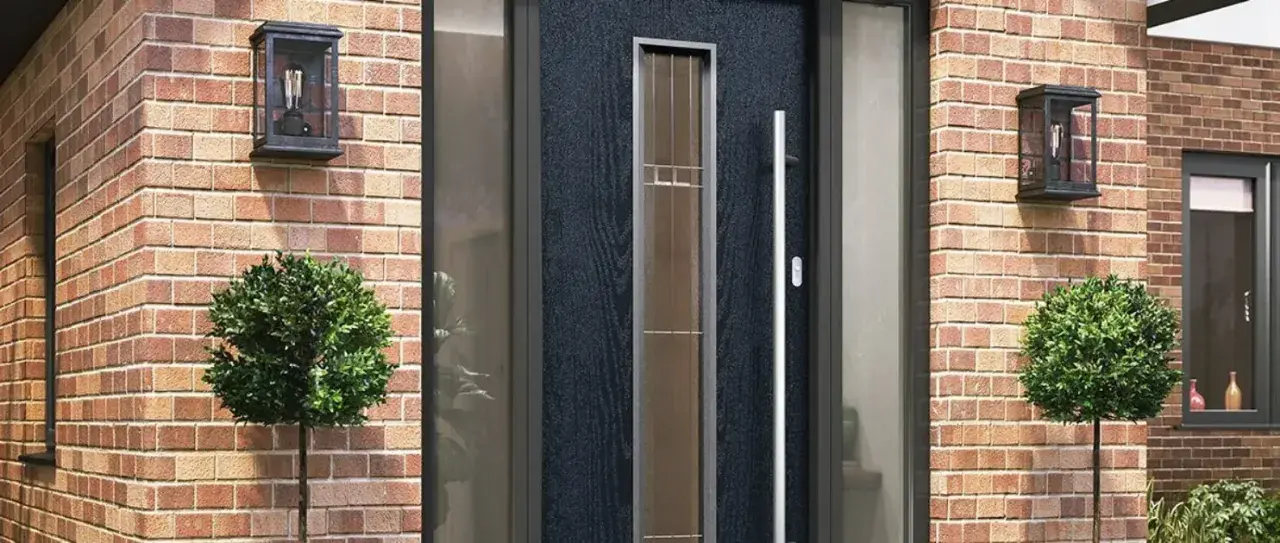 Black composite front door with glazed sidelights and a long pull handle
