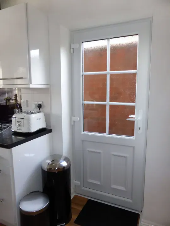 White uPVC back door with Georgian bars fitted in a kitchen
