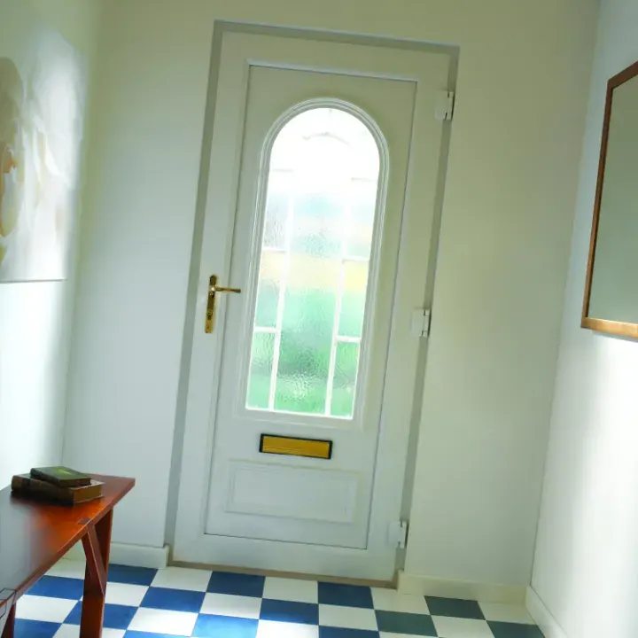 Interior view of a white uPVC entrance door with arched decorative glazing