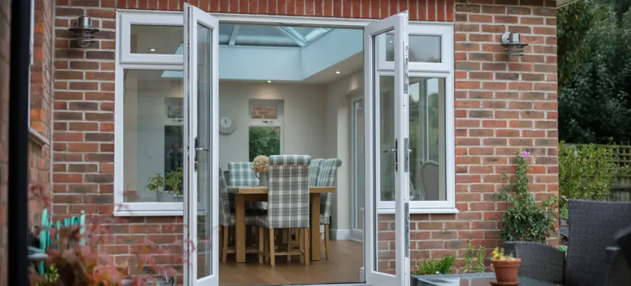 White uPVC French doors opened onto a garden patio