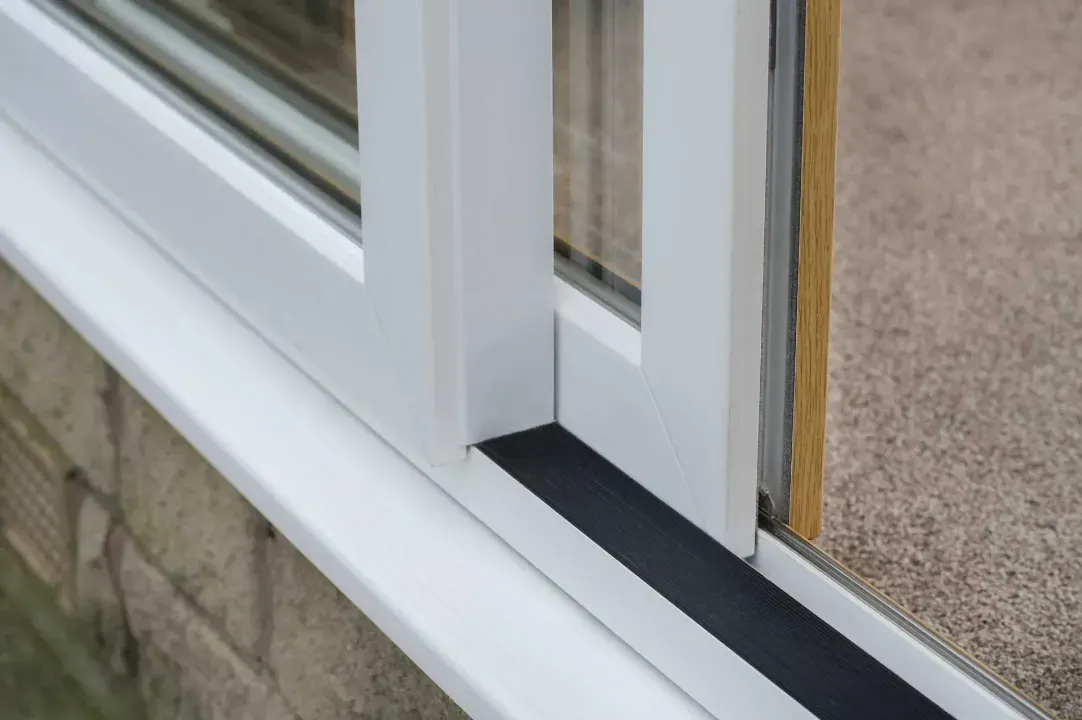 Close-up of a white uPVC sliding patio door frame and track