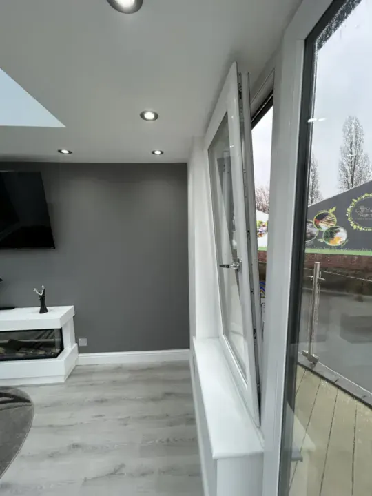 White uPVC tilt and turn window tilted open for ventilation