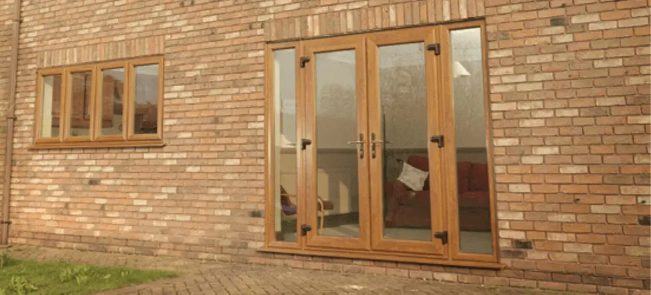 Wood-effect uPVC French doors with glazed side panels fitted to a brick home
