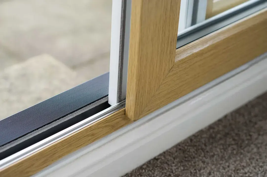 Close-up of a wood-effect uPVC sliding patio door and low threshold track