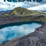 Volcanic crater lake with green hills and cloudy sky in Iceland.