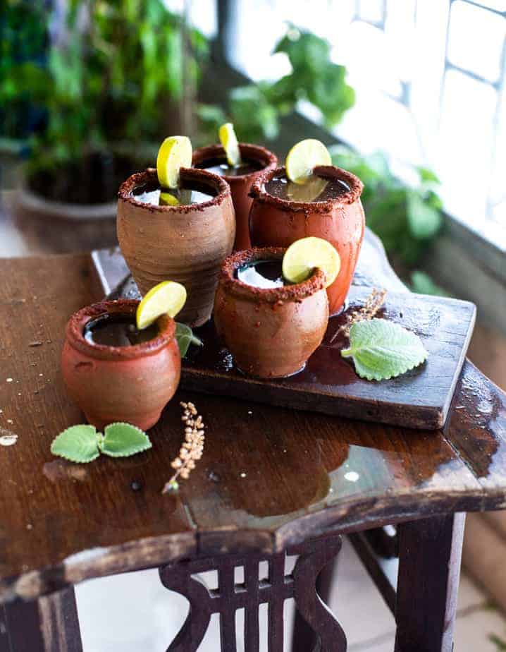 Tamarind Margarita in clay glasses with lemon slices