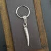 Silver horn spike earring by Antikuos jewellery, close-up