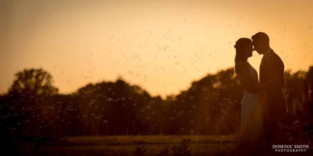 Sunset Wedding Photo with Bubbles at Brookfield Barn in Sussex with your Sussex Wedding Photographer