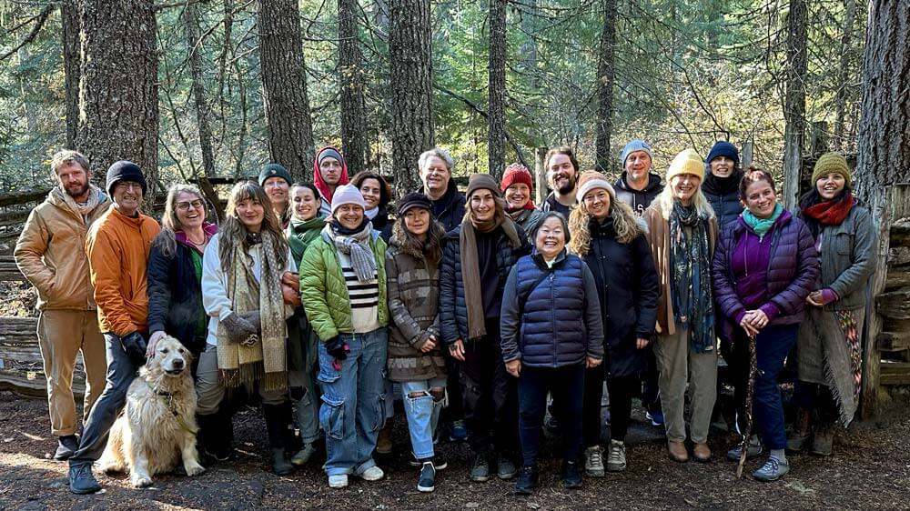 A group of people standing in a group in the forest