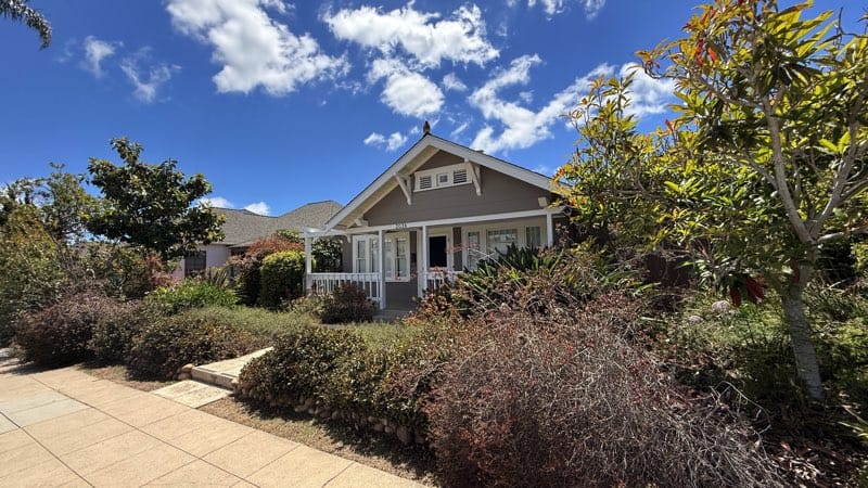 Craftsman-style home in North Park near Morley Field with a covered front porch, white trim, blue sky, and drought-tolerant landscaping.