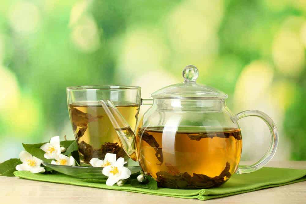 Green tea with jasmine in cup and teapot