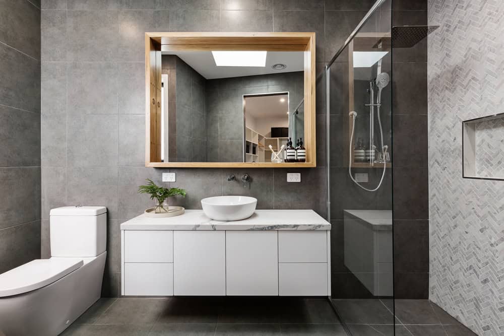 A bathroom renovation can get expensive quickly if you don’t plan it thoroughly in advance. By putting timely thought into the redesign, you might even find out that you don’t actually need a full, potentially costly renovation, and that just a few tweaks will do. Or, you might find out that you do need to do a lot more than a few simple tweaks, in which case it is much better to know that beforehand. Here are four bathroom renovation and remodelling ways to help give your bathroom a facelift and a functionality makeover. Keep these simple tips in mind to maximise space and reduce costs when you plan your bathroom renovation. Use Waterproof Boards A great way of changing the look of your bathroom without burning a hole in your pocket is to use prefabricated waterproof boards. A waterproof board such as a Wedi board, for example, is an extremely handy and versatile piece of bathroom building components. London-based waterproof tile board manufacturer Just Wedi has been in business for over two decades and is known for durability and modern design. Their boards can be used to create waterproof shelves, partitions, seating, and even the waterproof flooring needed for a wet room. Waterproof boards can also improve insulation and help keep mould and moisture in check. Use Alcoves, Niches and Recesses Is your bathroom space tiny? There are a lot of ways to maximise the space you do have. Your medicine cabinet and soap dishes can be built into niches and alcoves within the walls to save space. You can also use a recessed toilet paper holder to reduce clutter. In addition, bathroom furniture such as small cabinets can also be hung above the floor and attached to the wall to let the floor stay uncluttered. This can give an illusion of space, as can glass doors and strategically placed mirrors. Recessed ceiling lighting is another space-saving idea. Bring in Some Greenery A quick way to upgrade your existing bathroom space is to hang some plants, potted plants if you have the space. Plants such as ferns can add a soothing touch of luxe to the space. Plants can also be kept on shelves or in space-saving alcoves. Adding a plant or two is not expensive, while the aesthetic benefits are many. Add Some Colour You can add gorgeous, bright pops of colour via pretty tiles. Unique tile designs or unexpected colours such as pale pink or duck blue can add a relaxing, elegant vibe to your bathroom space. Or, to cut costs, you can also use attractively coloured bath and shower mats and curtains. If you have shelves or alcoves, you can consider adding flowers or simple yet colourful, waterproof a