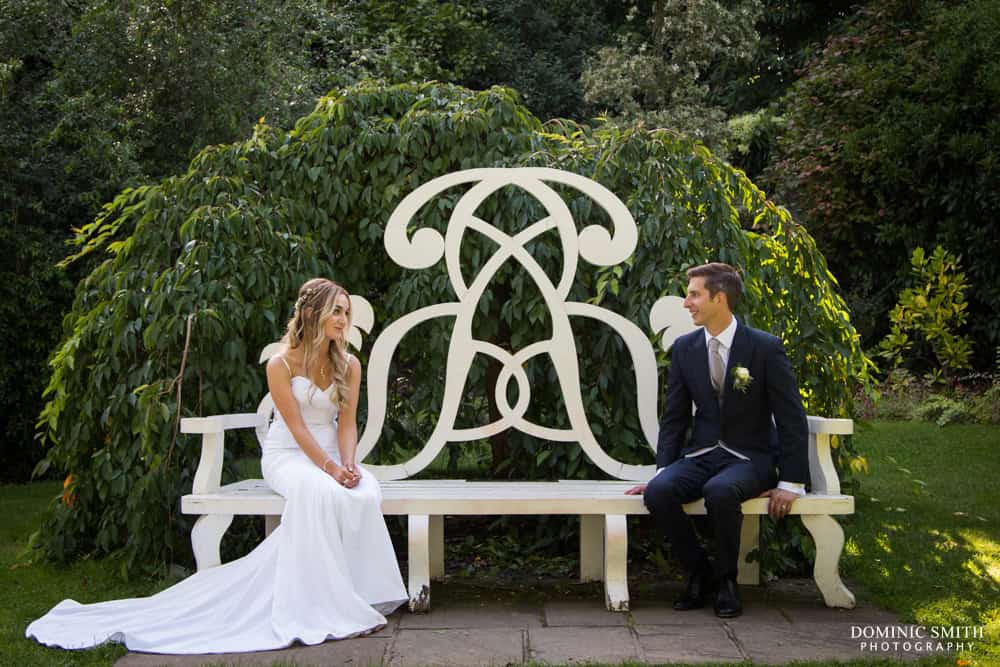 Wedding photo taken on the bench at Nymans