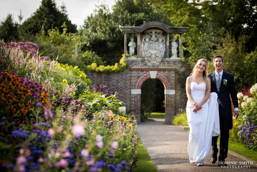 Wedding photo taken walking through the gardens at Nymans