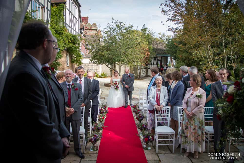 Bride walking down the aisle at Ravenswood Hotel