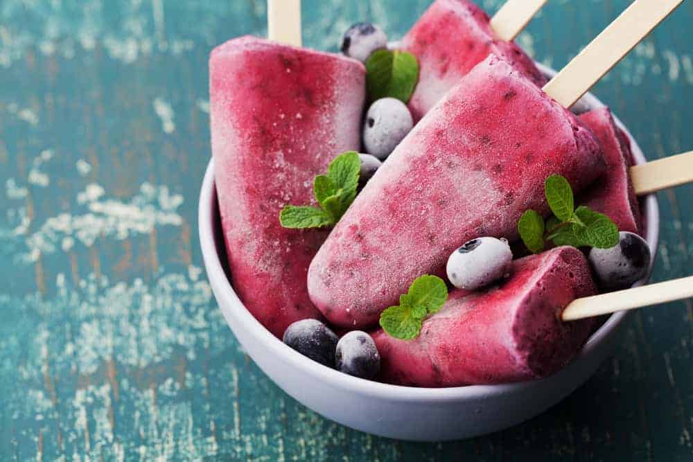 A bowl of red fruit ice lollies