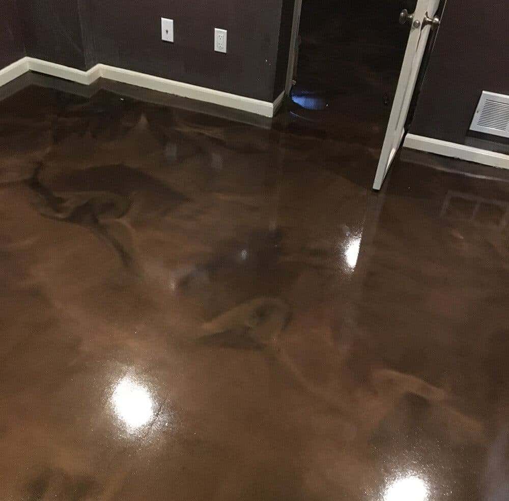 Polished brown stained concrete floor in a residential interior, showcasing a glossy finish and elegant design by a Minnesota concrete contractor.