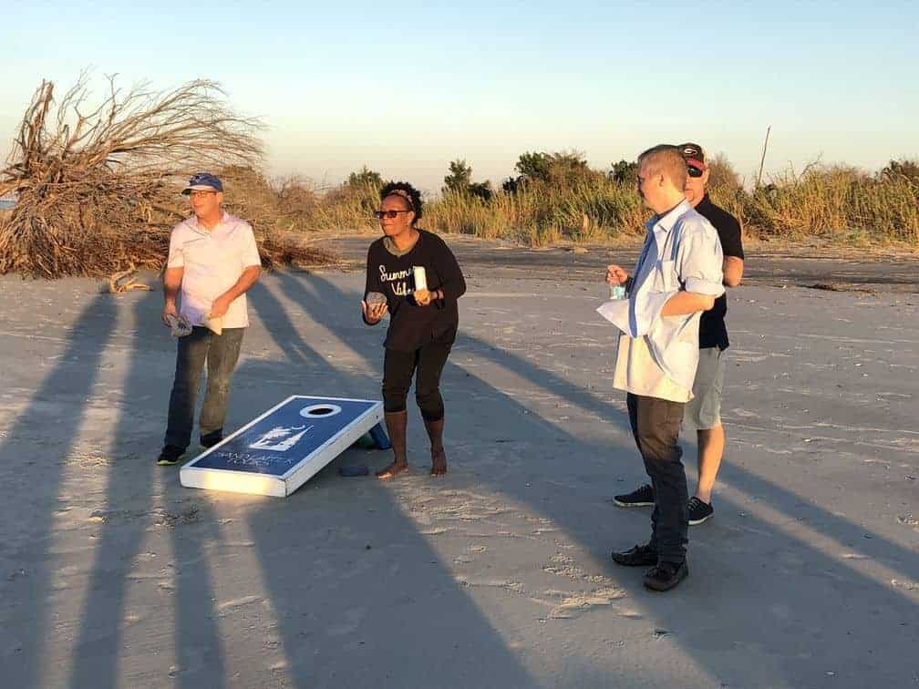 Playing corn hole on the beach. Party boat rental Charleston, SC