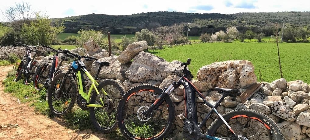 Bikes leaning on a stone wall on a Sicily Hike and Bike Tour from Catania, Italy