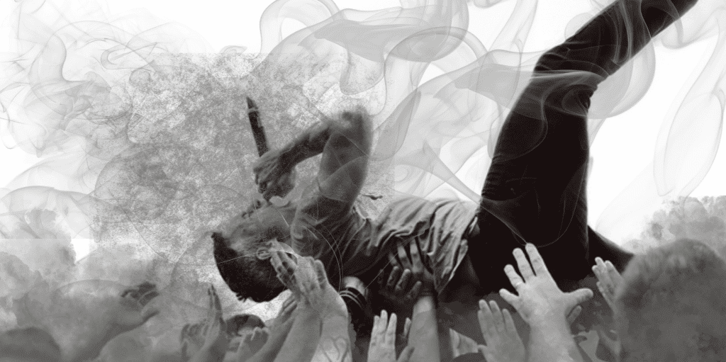A person crowd surfing at a concert with smoke effects, symbolizing music festival culture and audience engagement; high-energy live music atmosphere.