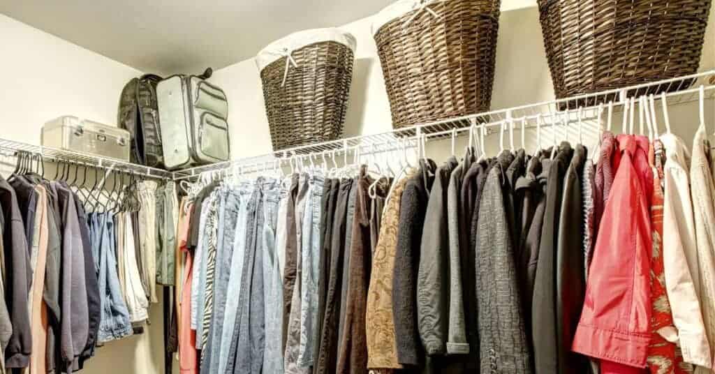 Walk-in closet with large baskets on a shelf